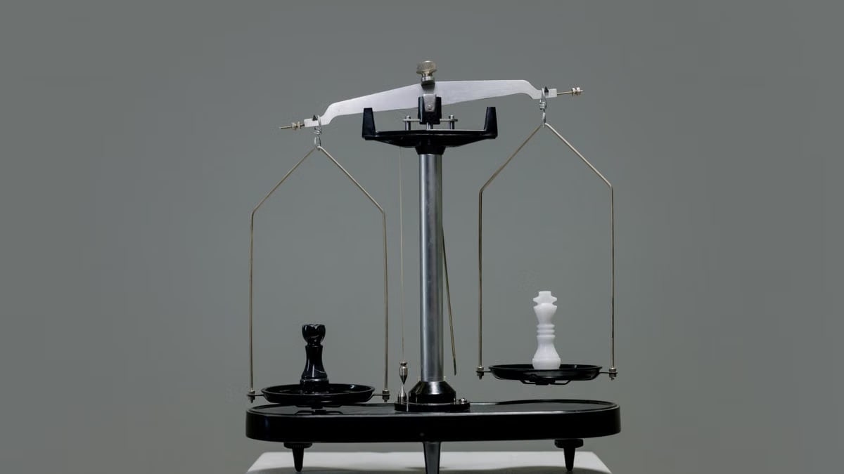 Chess pieces balanced on a scale depicting equality or strategy in decision making.